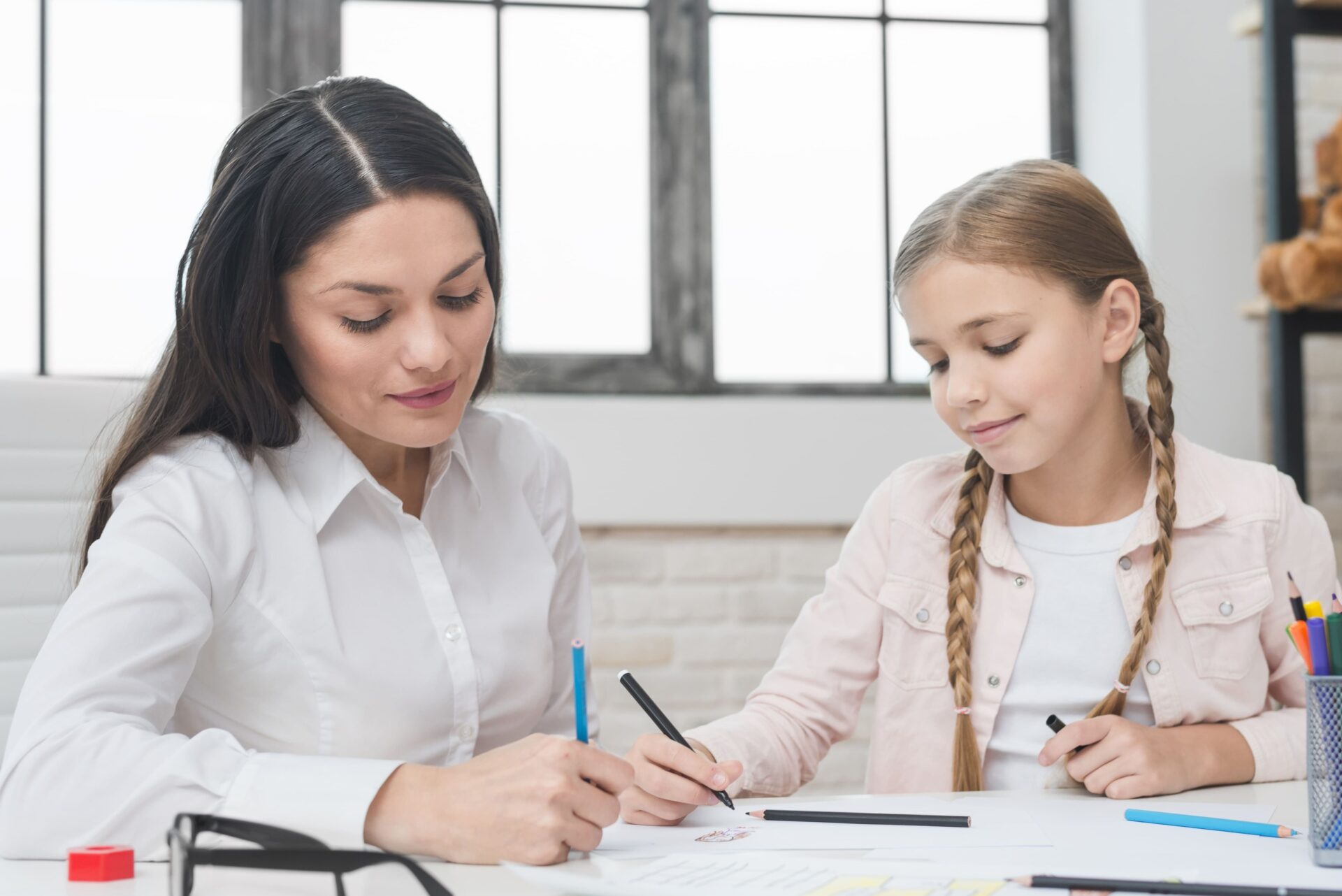 Teacher supporting a child with a learning activity