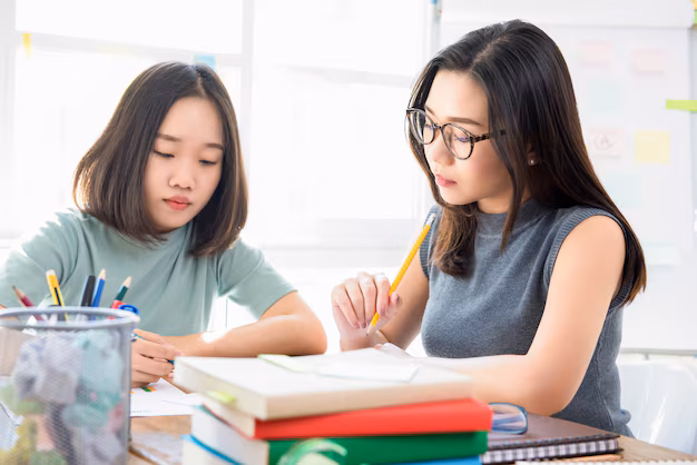 Teacher supporting student during one-to-one learning.